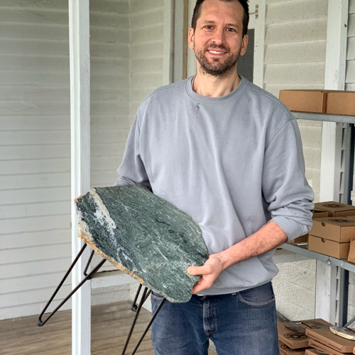 American Stonecraft owner, Gerald Croteau, models a Table with Shaker Village Slab